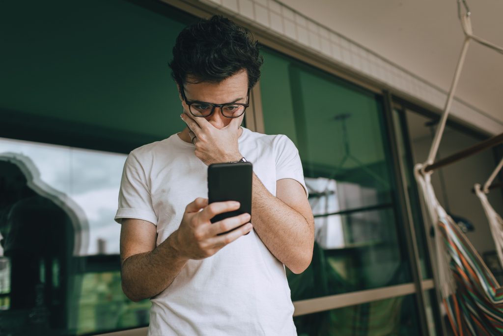 Business owner checking a missed call on their phone that could represent a lost junk removal customer.